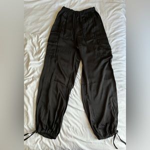 PINK. Black satin parachute pants. Size XS.